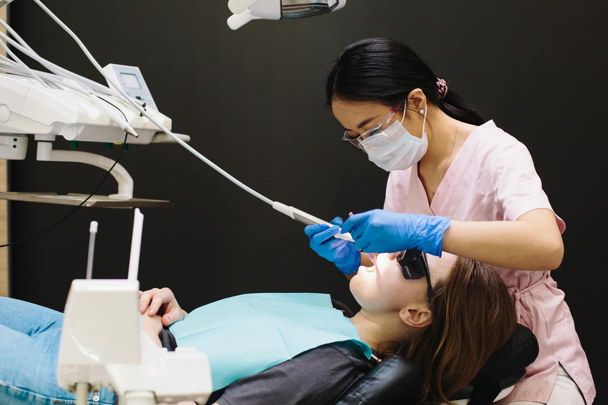 Professional dentist conducting an oral examination on a patient in a modern dental clinic.